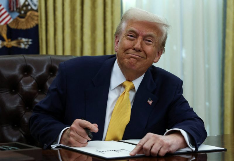 U.S. President Donald Trump signs an executive order in the Oval Office of the White House in Washington, D.C., U.S., March 7, 2025. REUTERS/Evelyn Hockstein